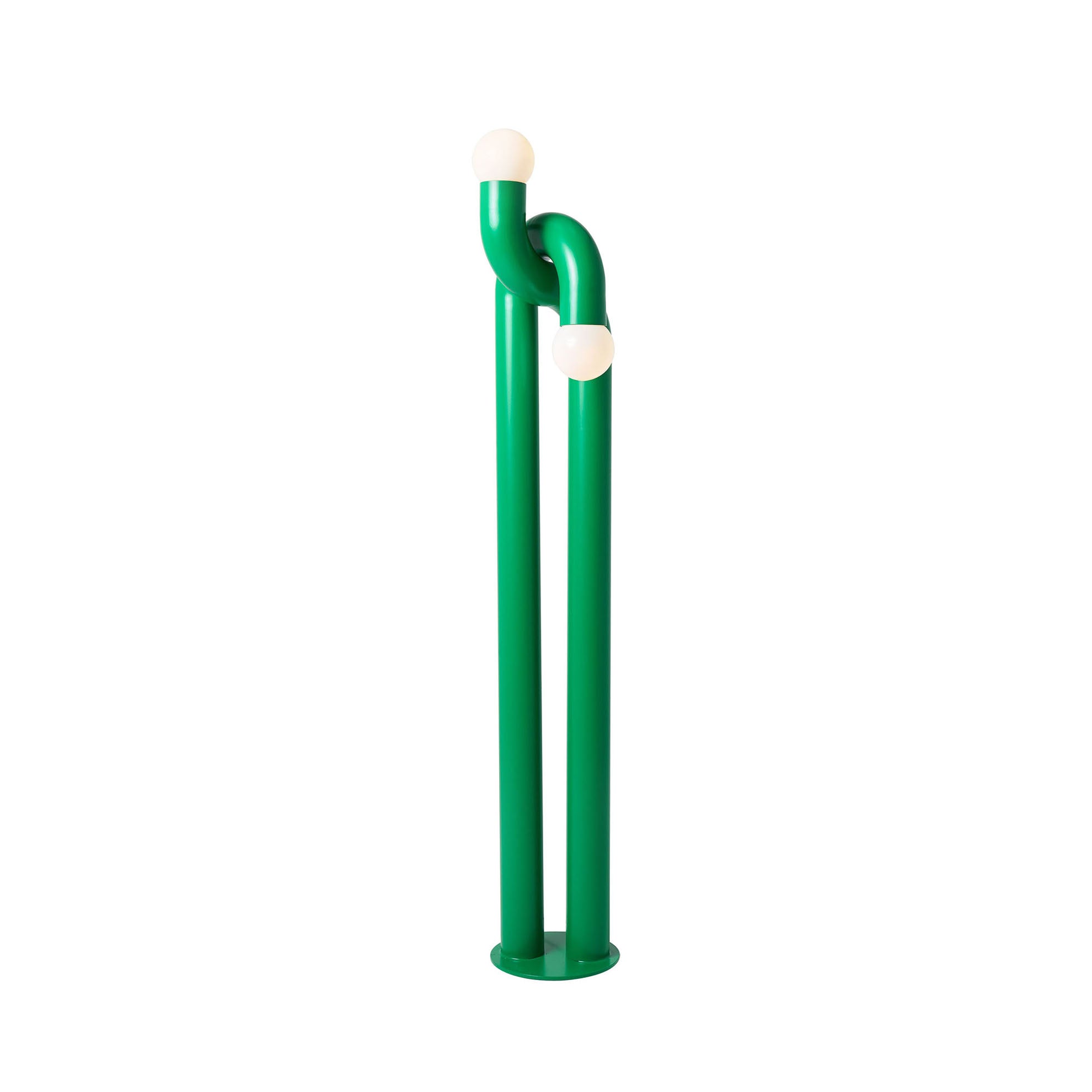 Modulation Floor Lamp in green, showcasing its linear iron body and two glass globes.