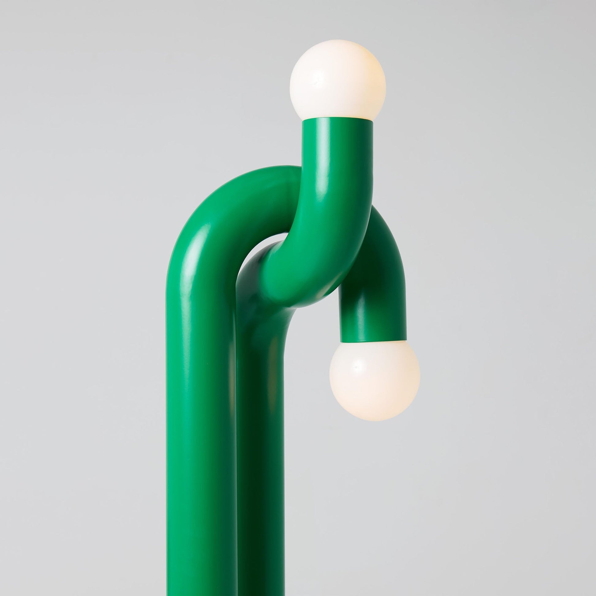 The orange Modulation Floor Lamp shown in a brightly lit room.