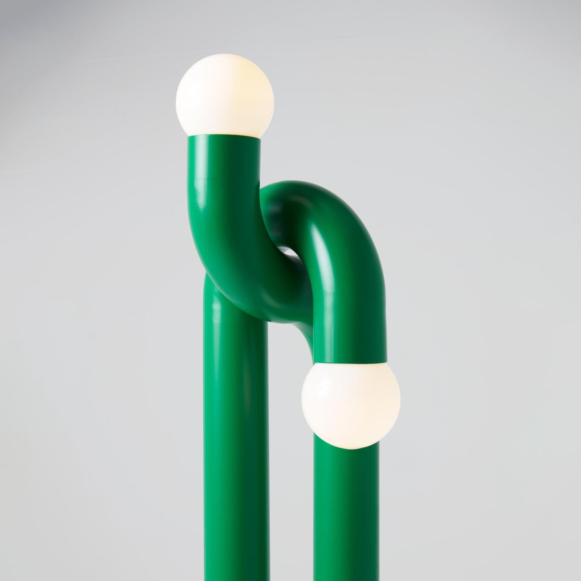 The black lamp as a sculptural art piece in a modern entryway.