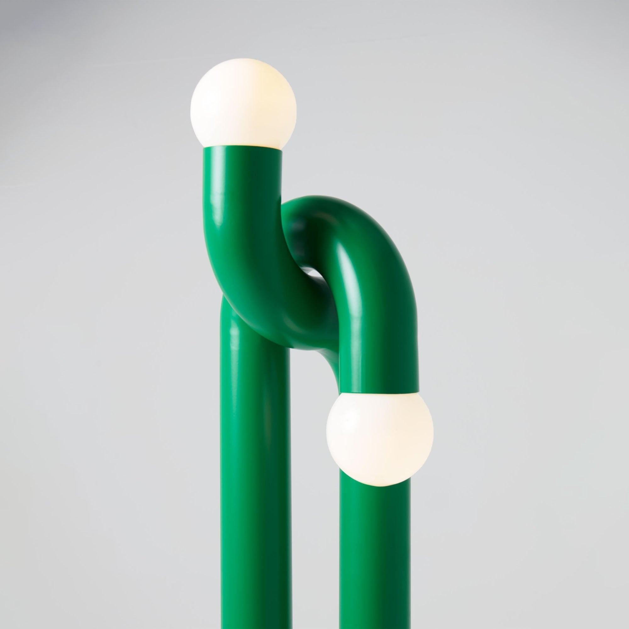 The black lamp as a sculptural art piece in a modern entryway.