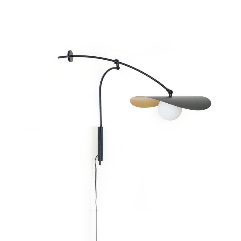 Myrna Wall Lamp casting a warm, ambient glow.