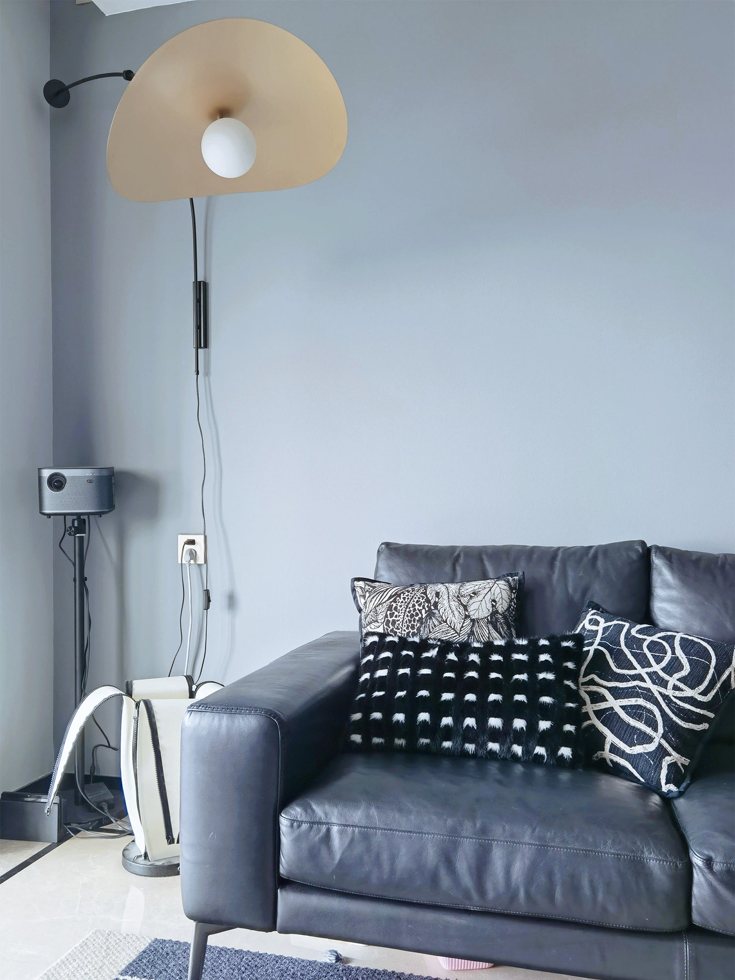 Lifestyle image featuring the Myrna Wall Lamp in a chic living room.