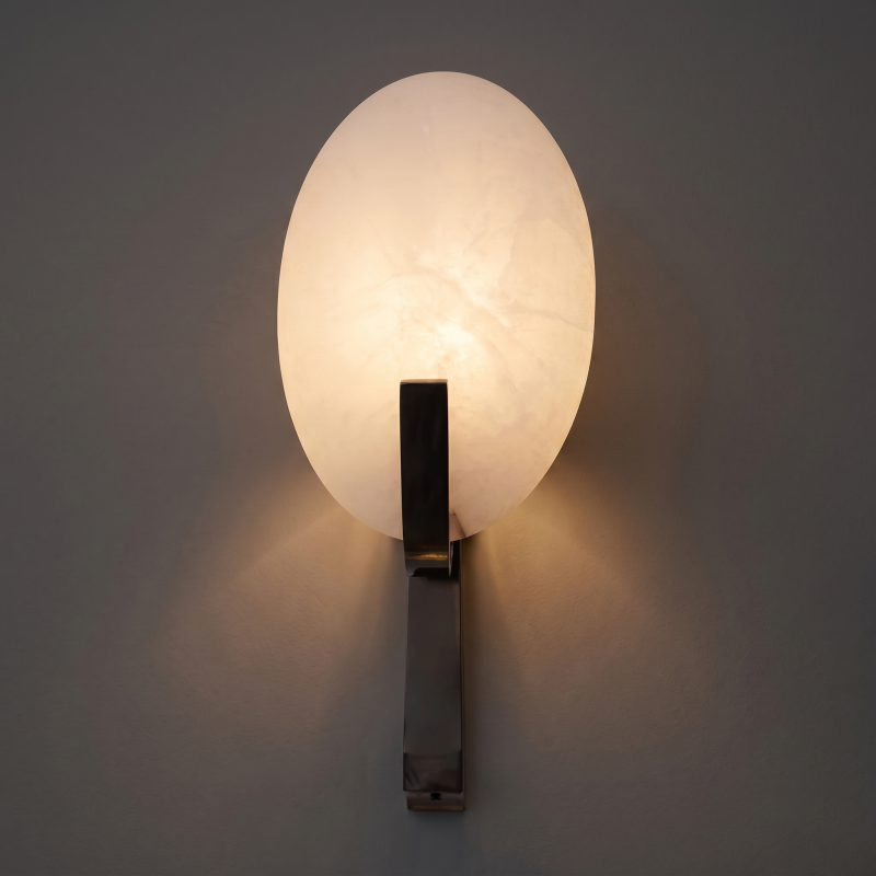 Tall multi-tier alabaster wall sconce in a grand entryway.