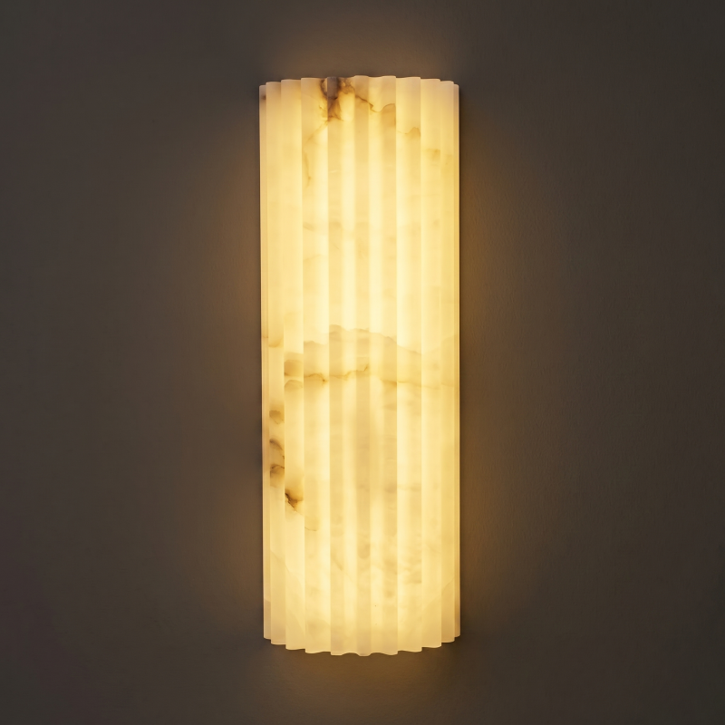 A series of alabaster wall lights illuminating a long corridor.