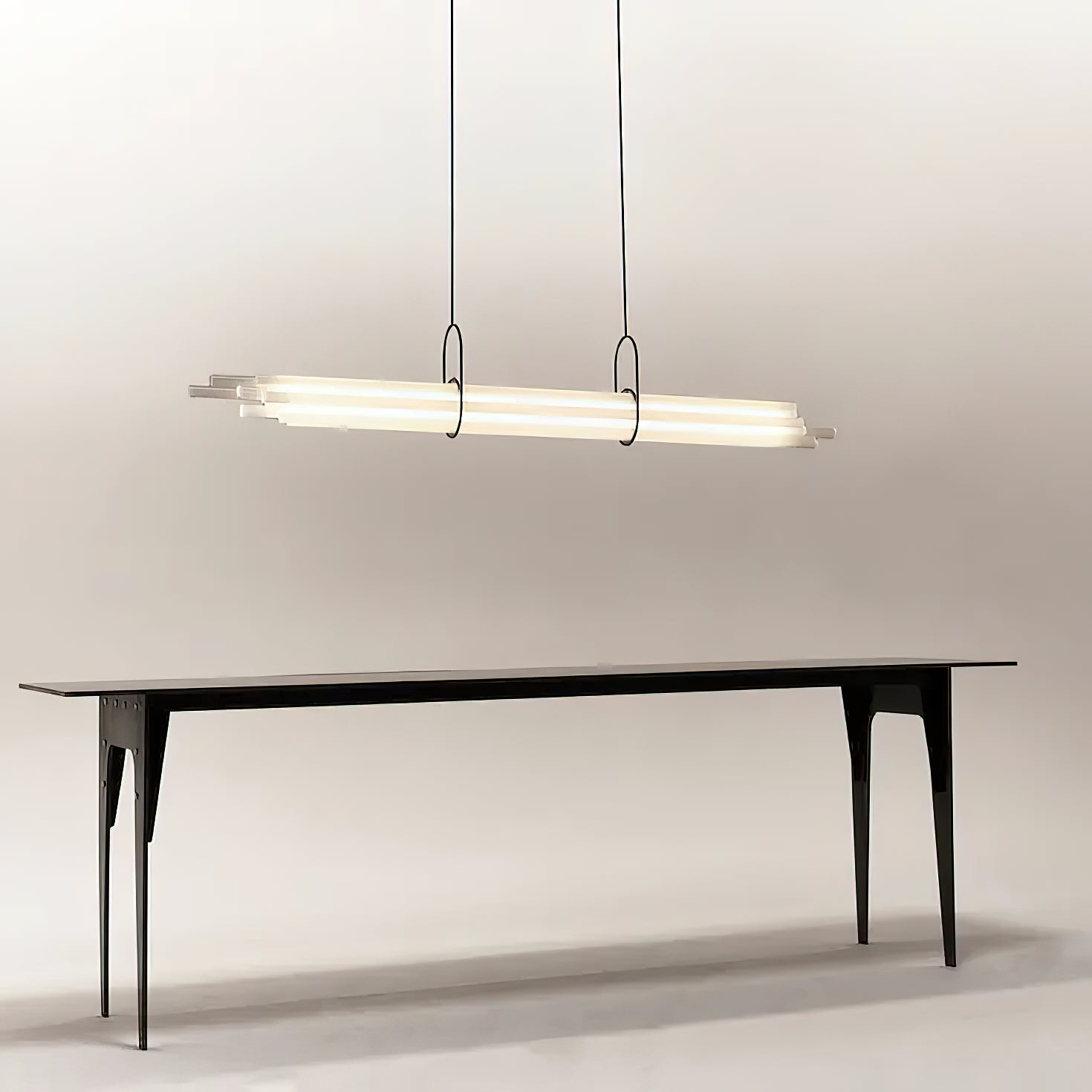 The NL 12 chandelier in a white finish, illuminating a kitchen island.