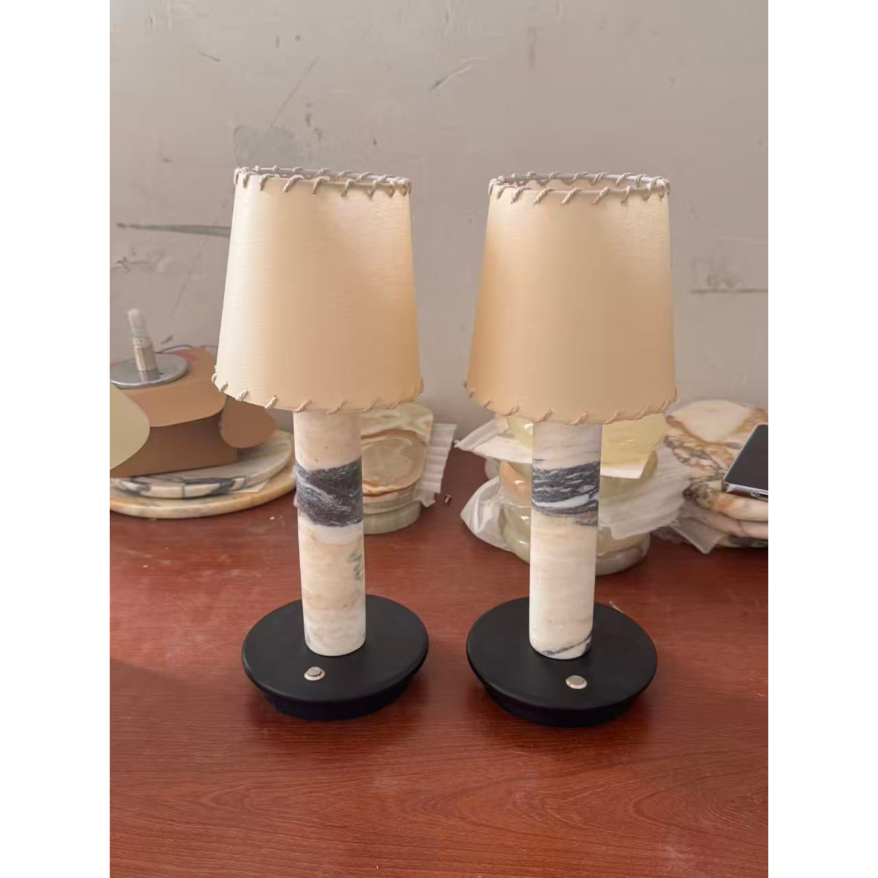 The Jorgen Table Lamp providing warm, ambient light in a bedroom setting.