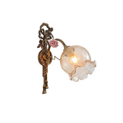 Neiman Wall Lamp with a brass body and clear glass shade.