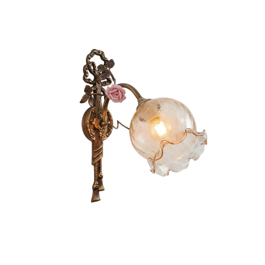 Neiman Wall Lamp with a brass body and clear glass shade.