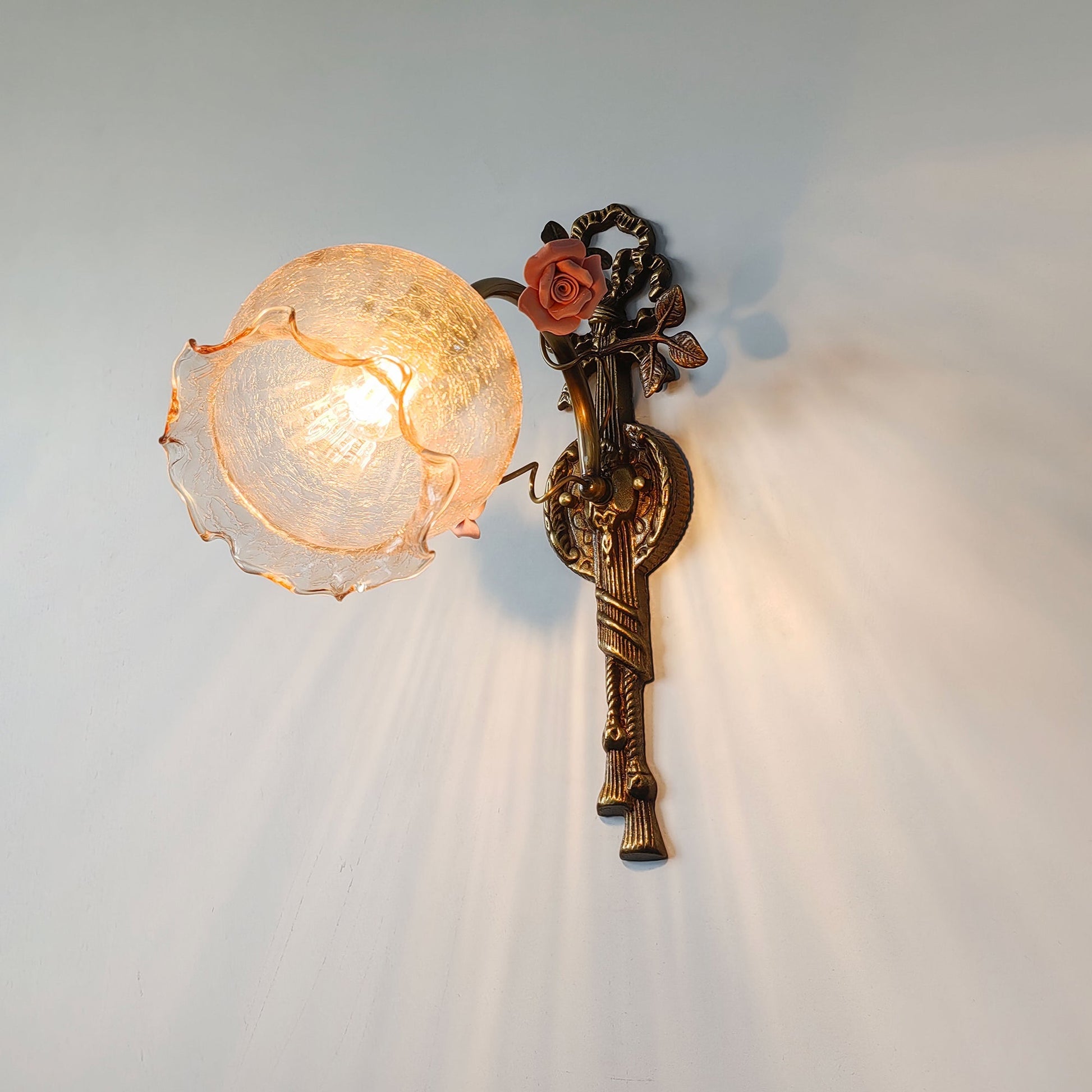 The Neiman Wall Lamp shown as a pair in a bedroom setting.
