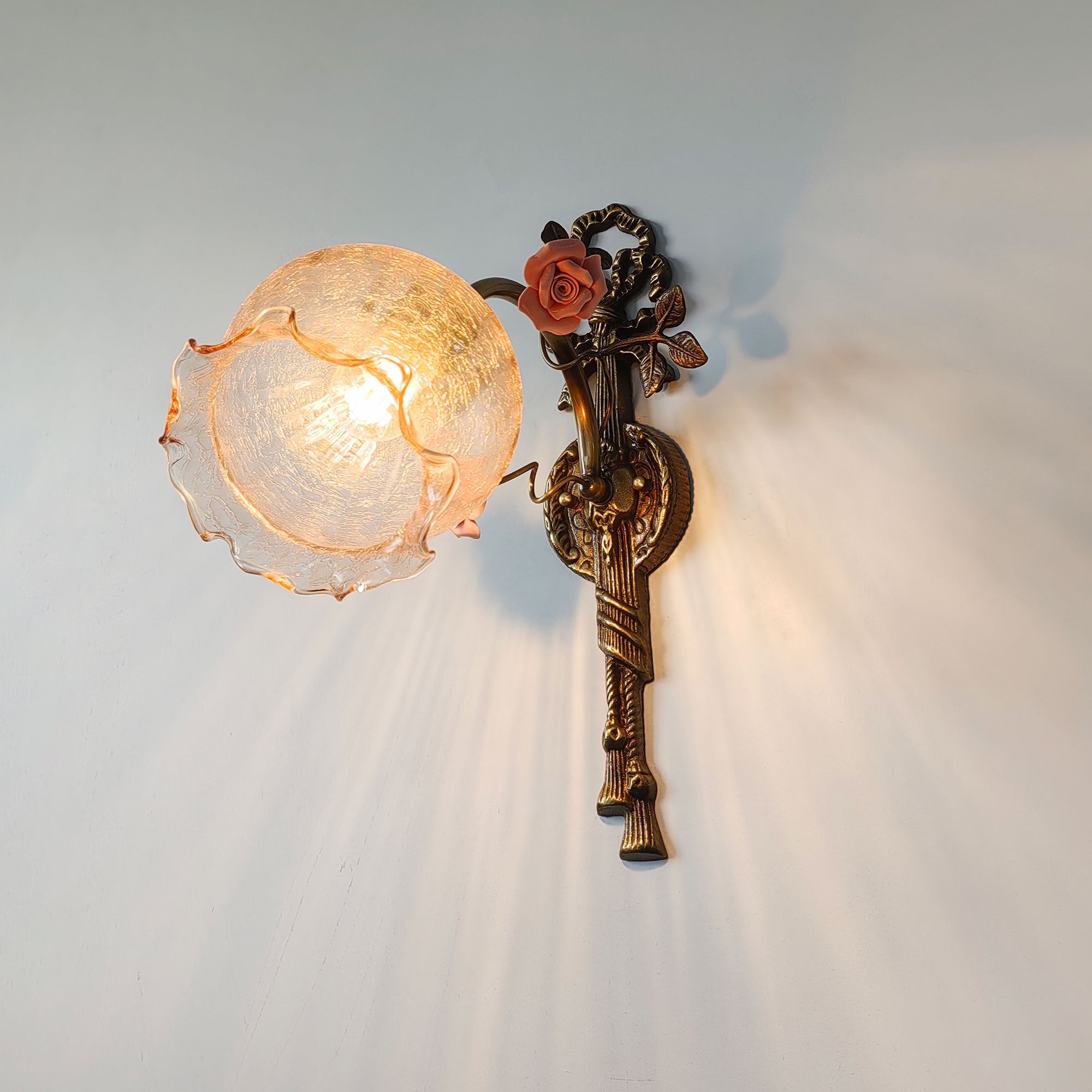 The Neiman Wall Lamp shown as a pair in a bedroom setting.