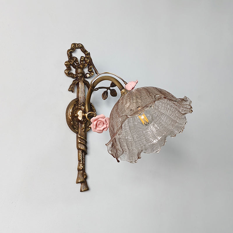 Detailed view of the ceramic flower against the brass body.