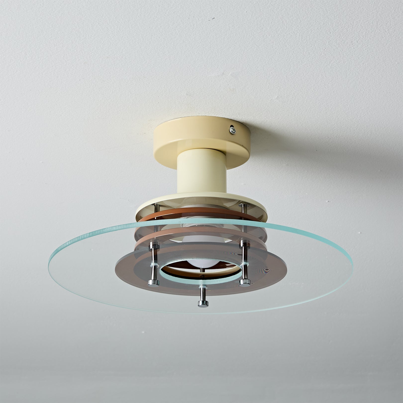 The transparent quality of the saucer-shaped glass shade.
