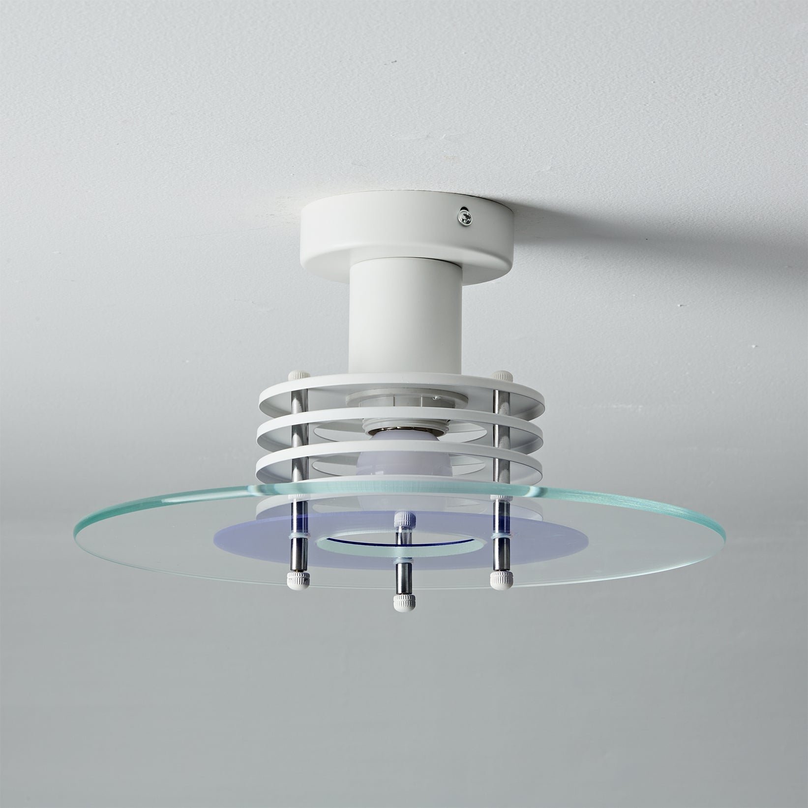 The Nello Ceiling Lamp shown in a minimalist interior setting.