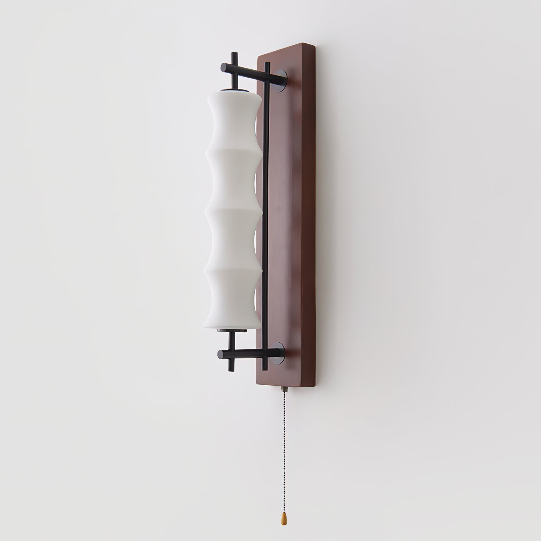 The Nesta wall sconce shown in the walnut color finish.