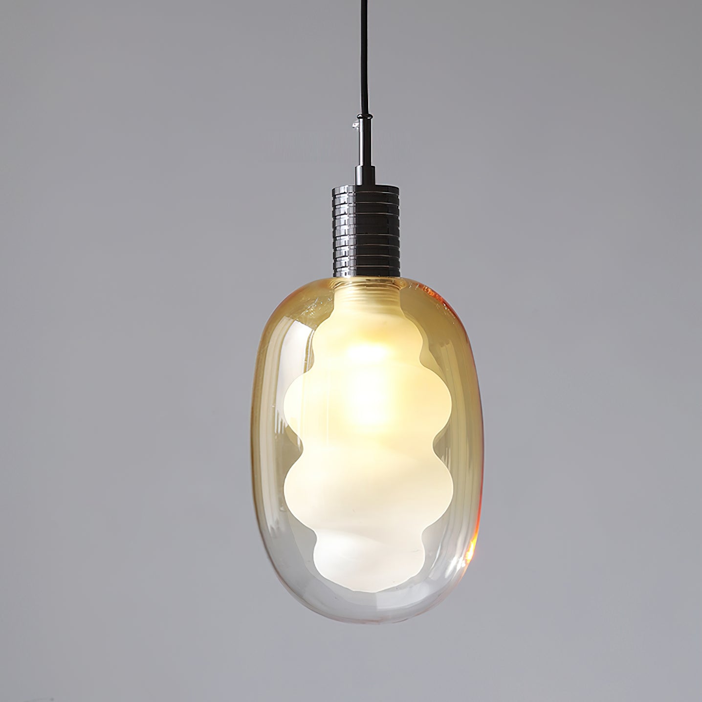 Niche Pendant Light shown in a modern dining area setting.