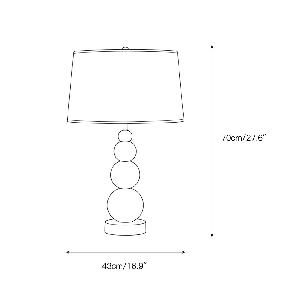 The Niobe Table Lamp shown on a living room side table.
