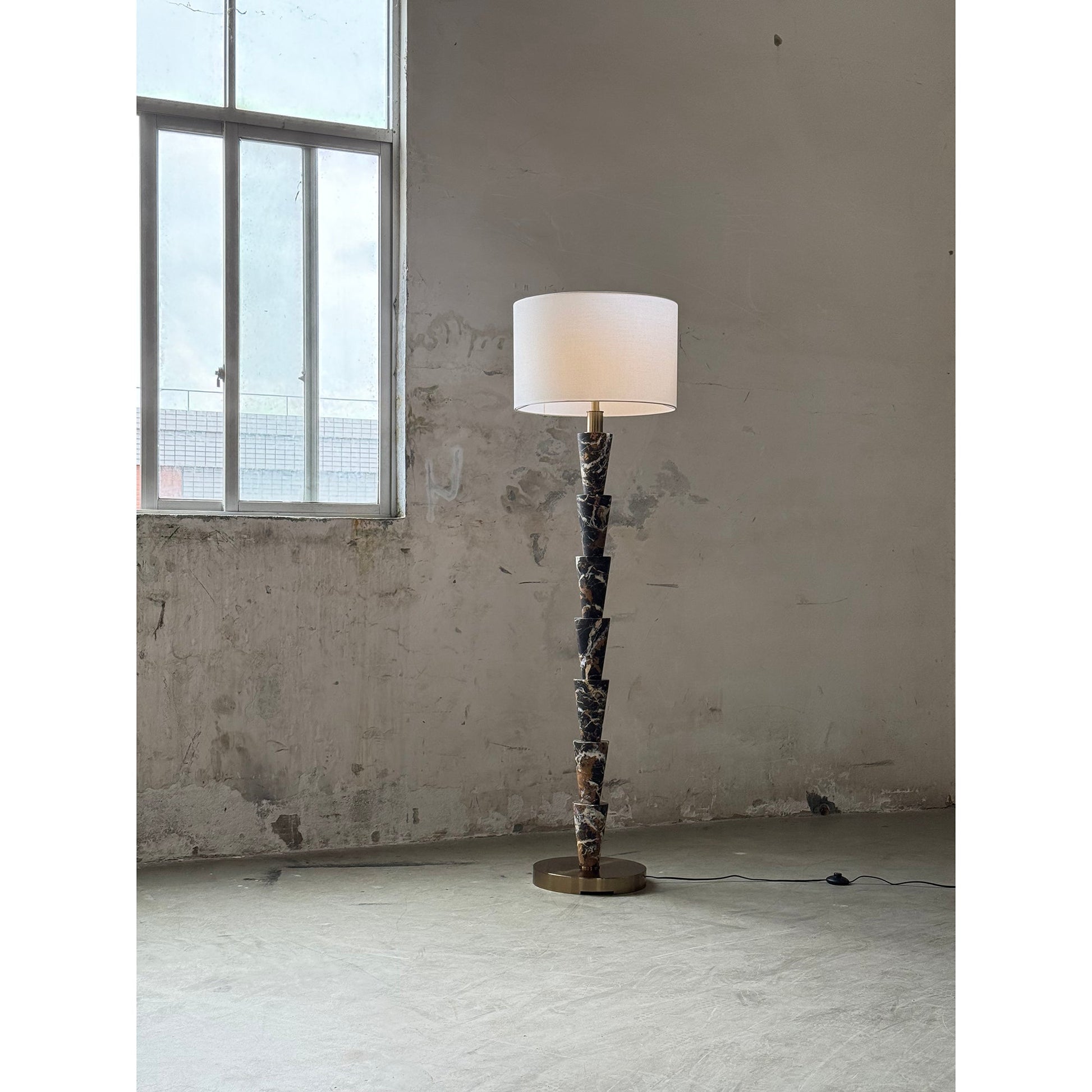 The lamp illuminating a cozy corner at night.