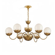 Noemie Chandelier with six arms in a brass finish against a plain background.