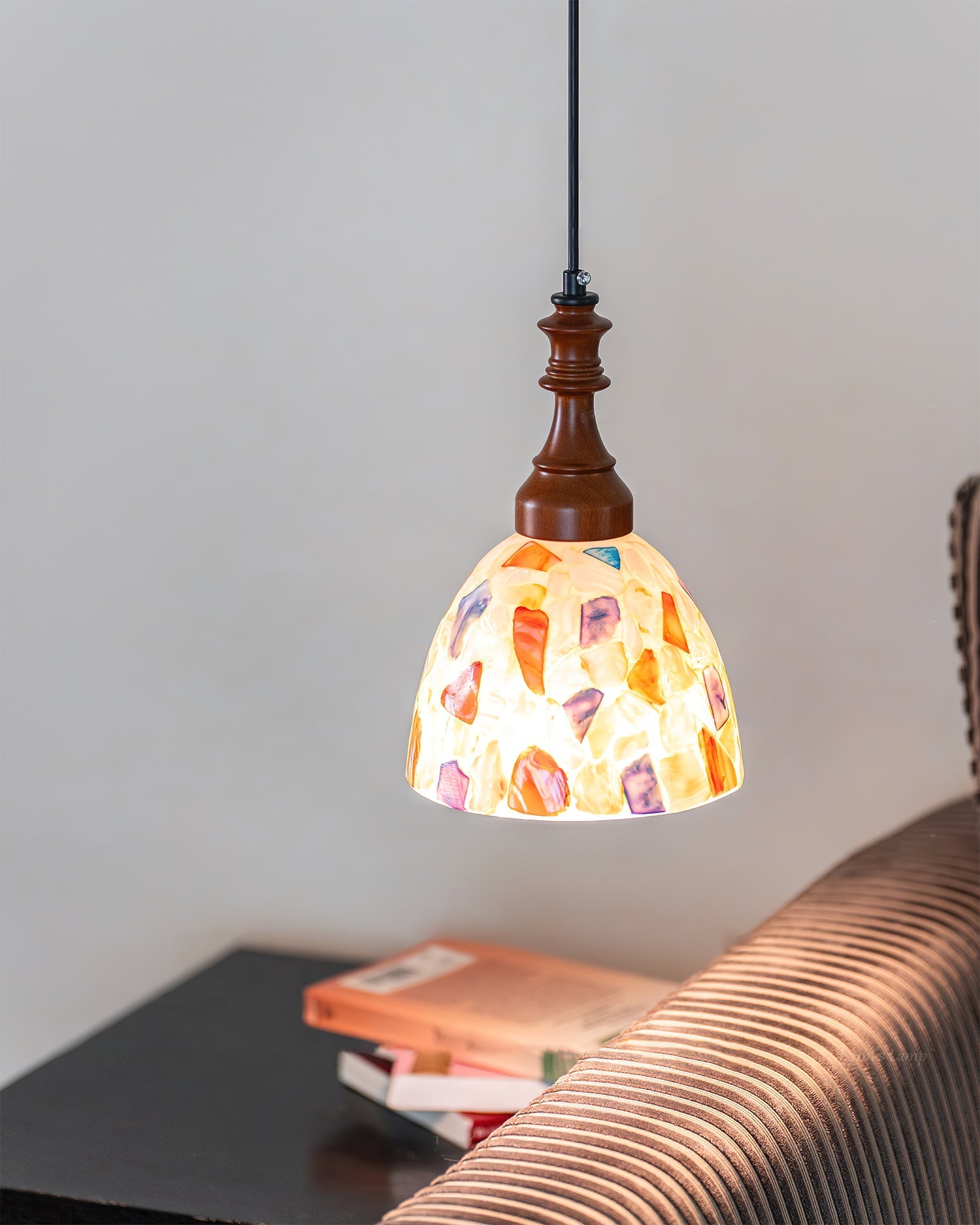 Detailed view of the metal and wood components of the pendant light.