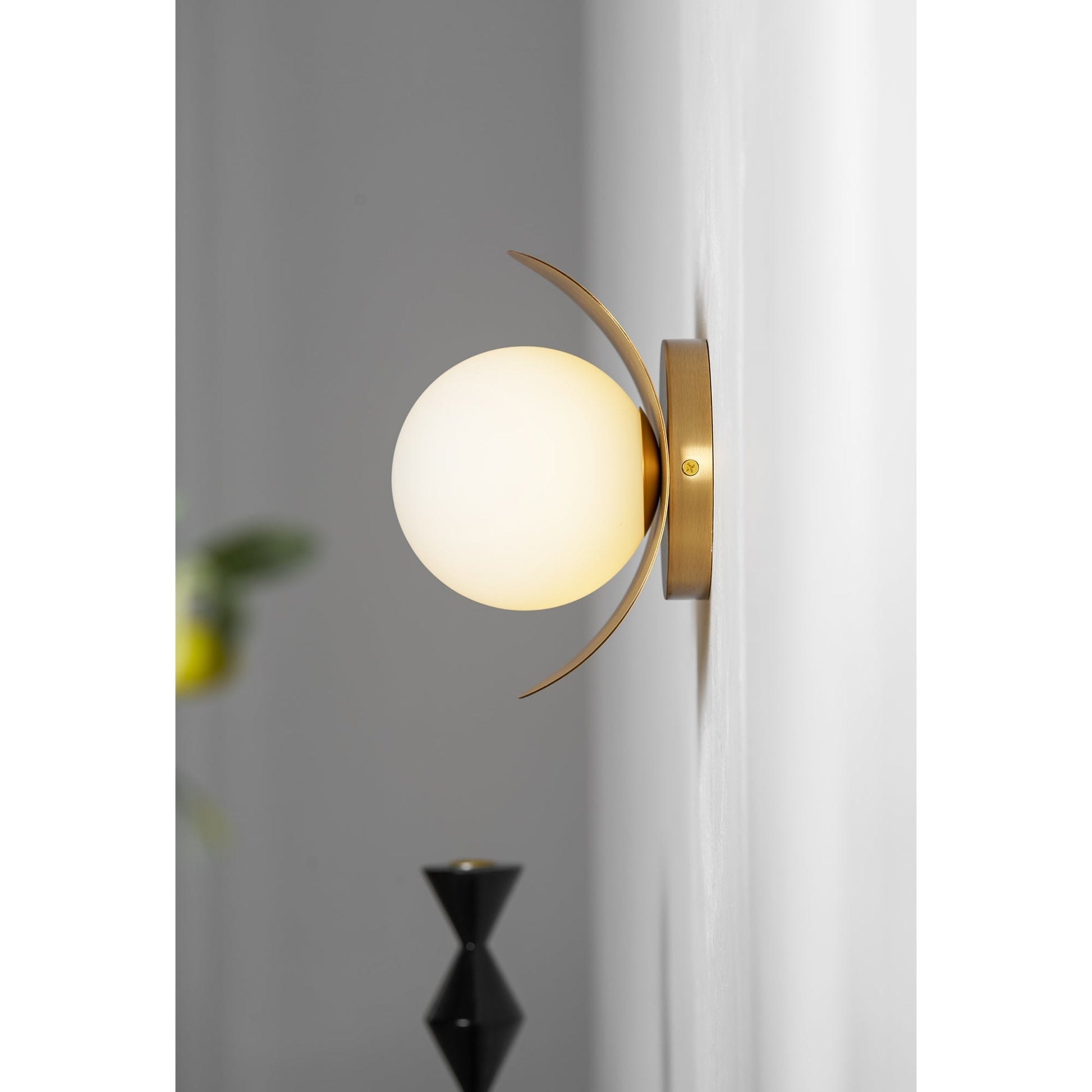 The Nouvel Wall Lamp mounted with the globe pointing downwards.