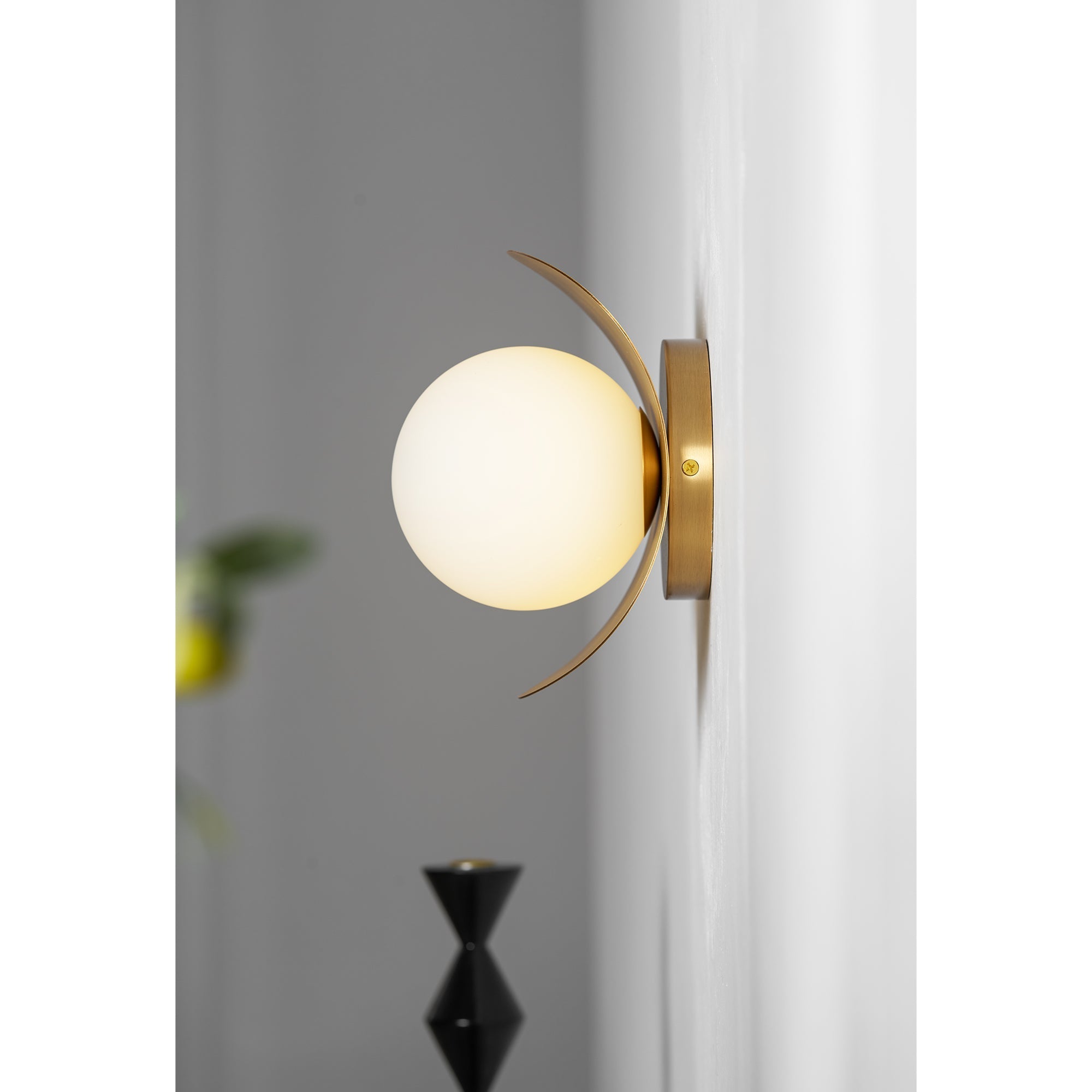 The Nouvel Wall Lamp mounted with the globe pointing downwards.
