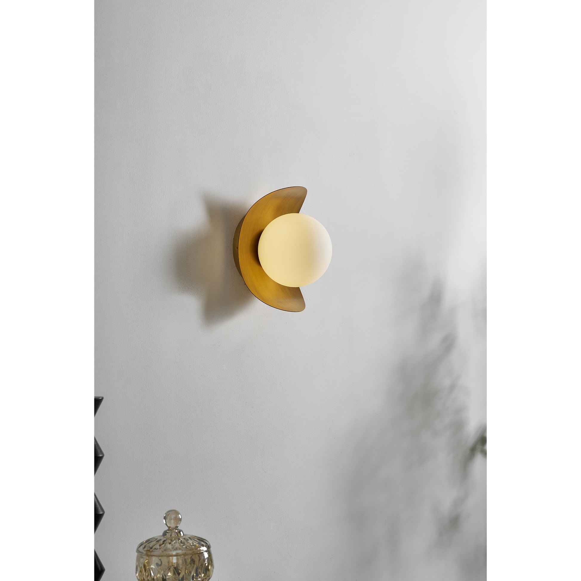 Nouvel Wall Lamp used as a bedside reading light in a minimalist bedroom.