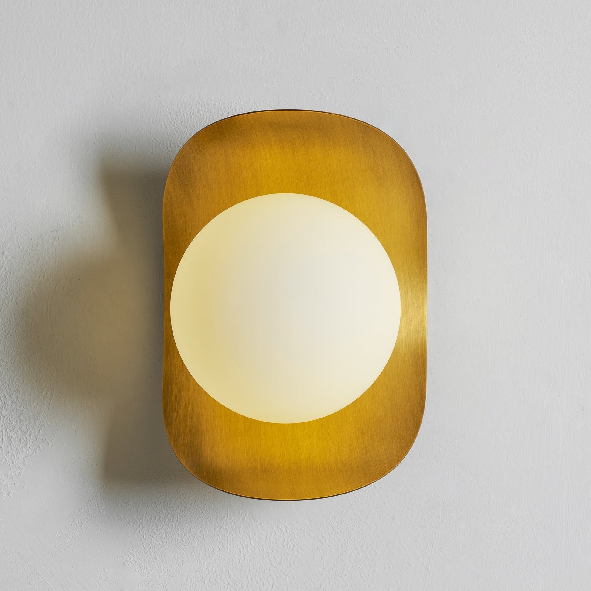 Unlit view of the Nouvel Wall Lamp in rose gold.