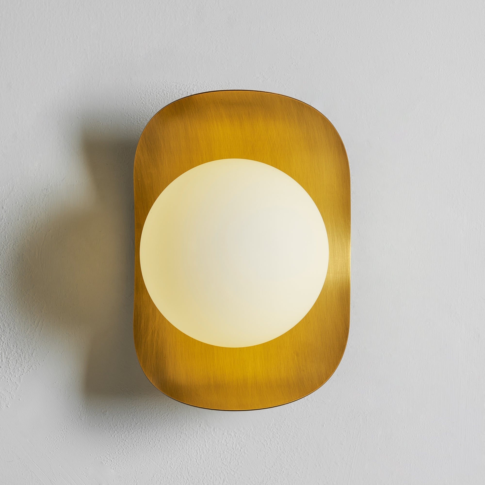 Unlit view of the Nouvel Wall Lamp in rose gold.