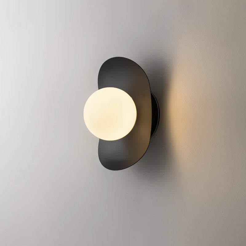 The clean white Nouvel Wall Lamp blending into a light-colored wall.