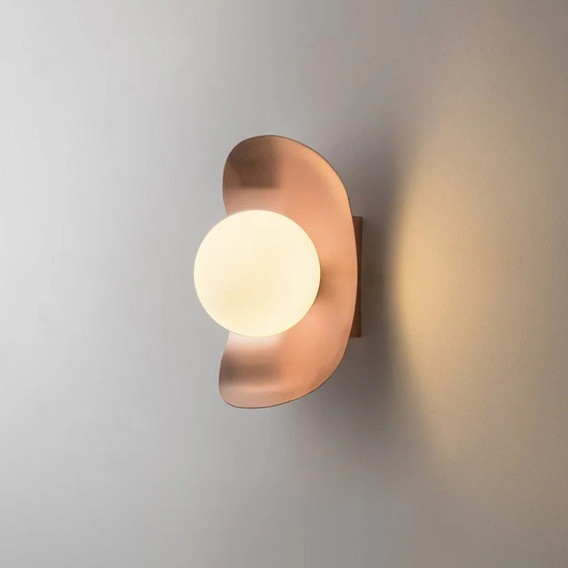 The warm, soft tone of the rose gold Nouvel Wall Lamp.