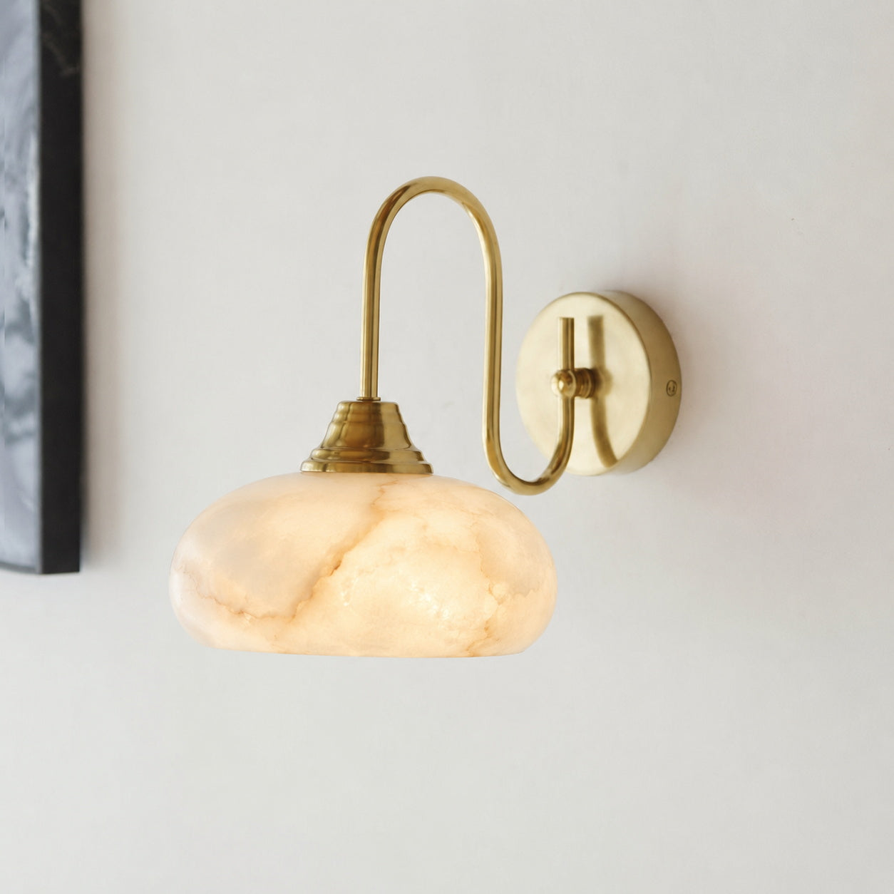 A pair of Nova Alabaster Wall Sconces installed on a feature wall.