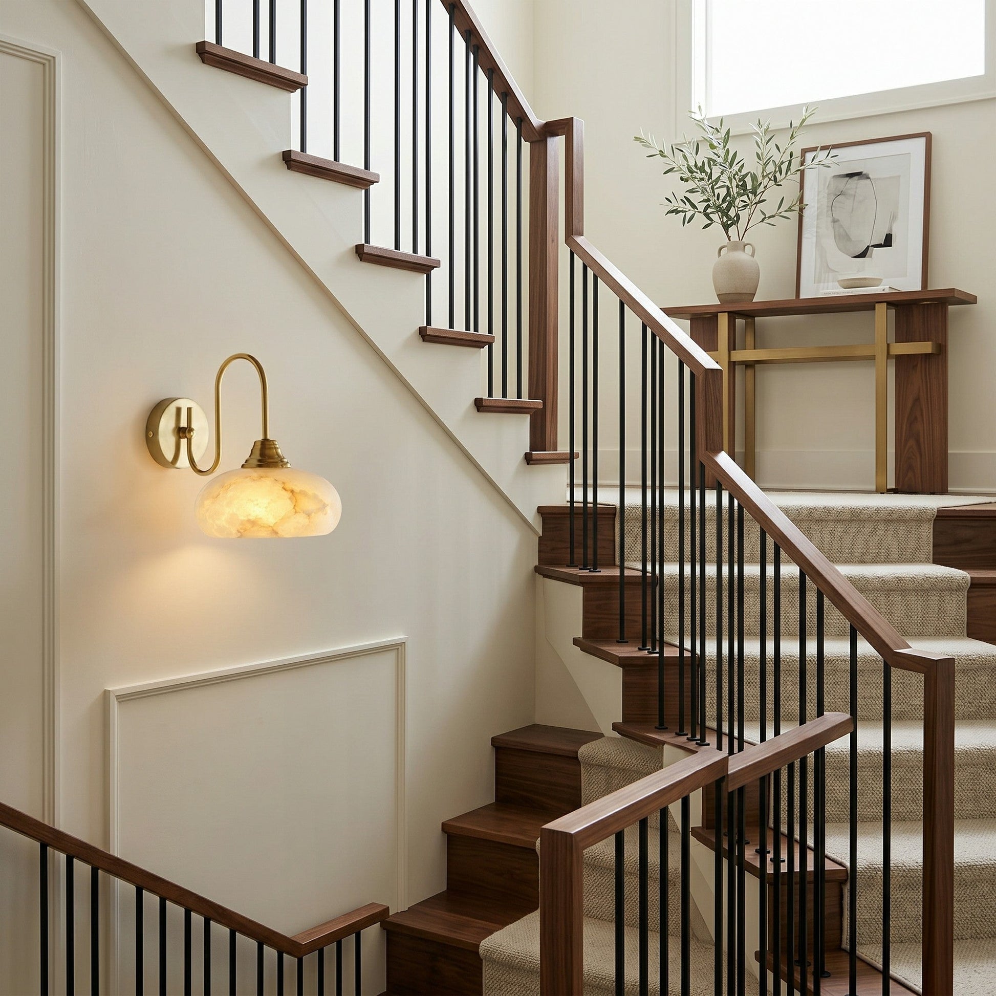 Lifestyle image of the Nova Alabaster Wall Sconce in a hallway.