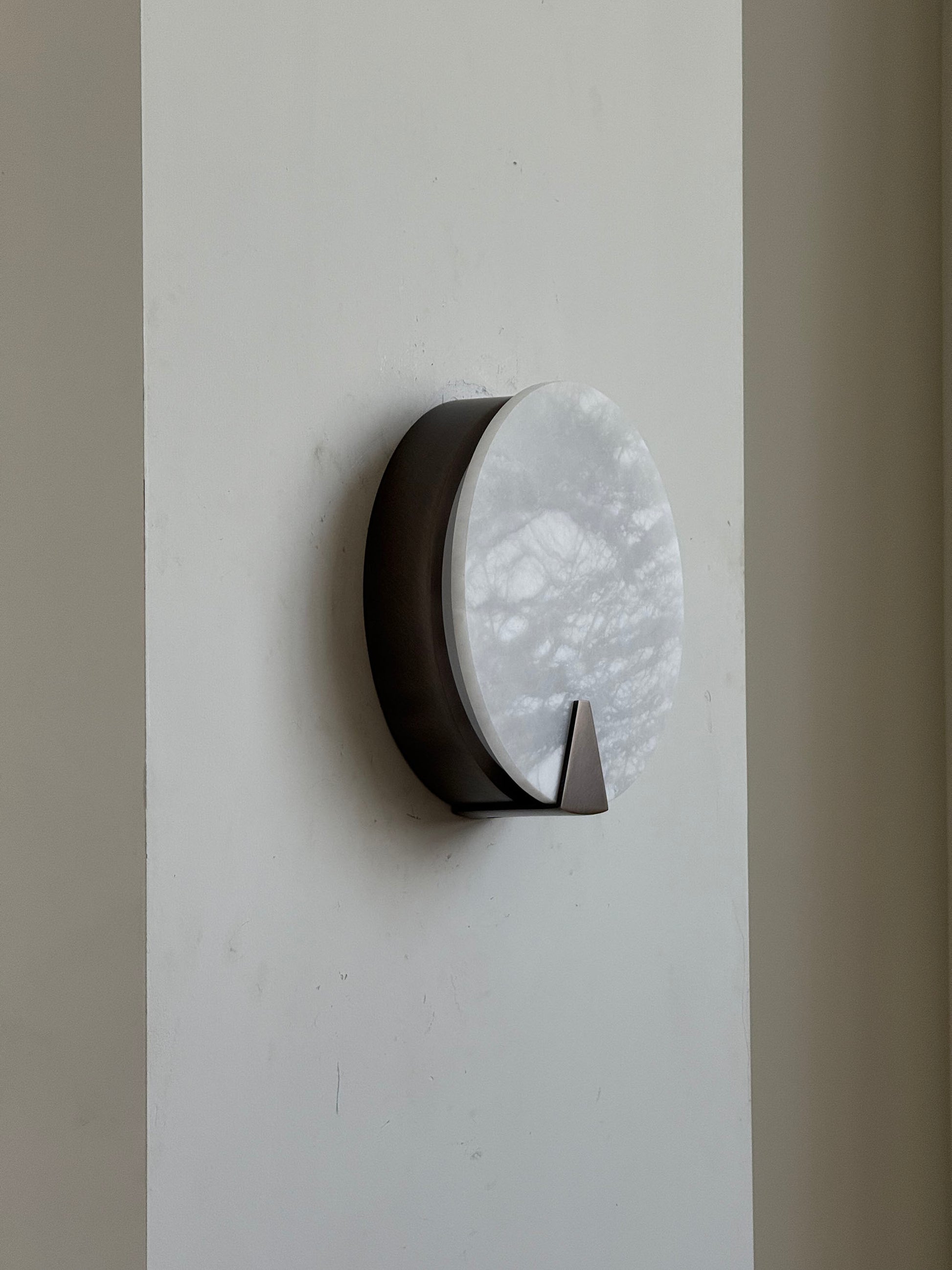 The Ophelia Sconce installed above a bedside table.