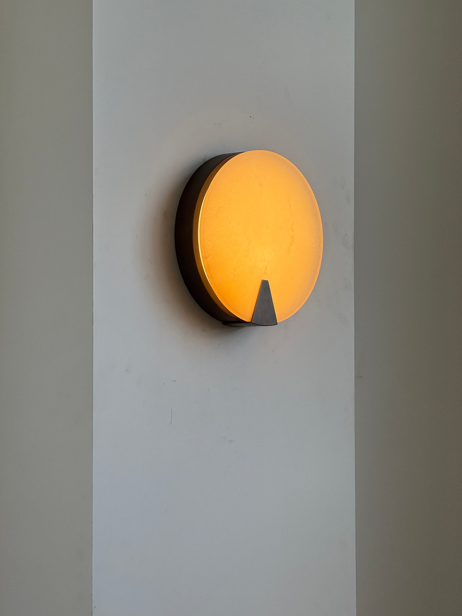 Front view of the Ophelia Alabaster Round Sconce.
