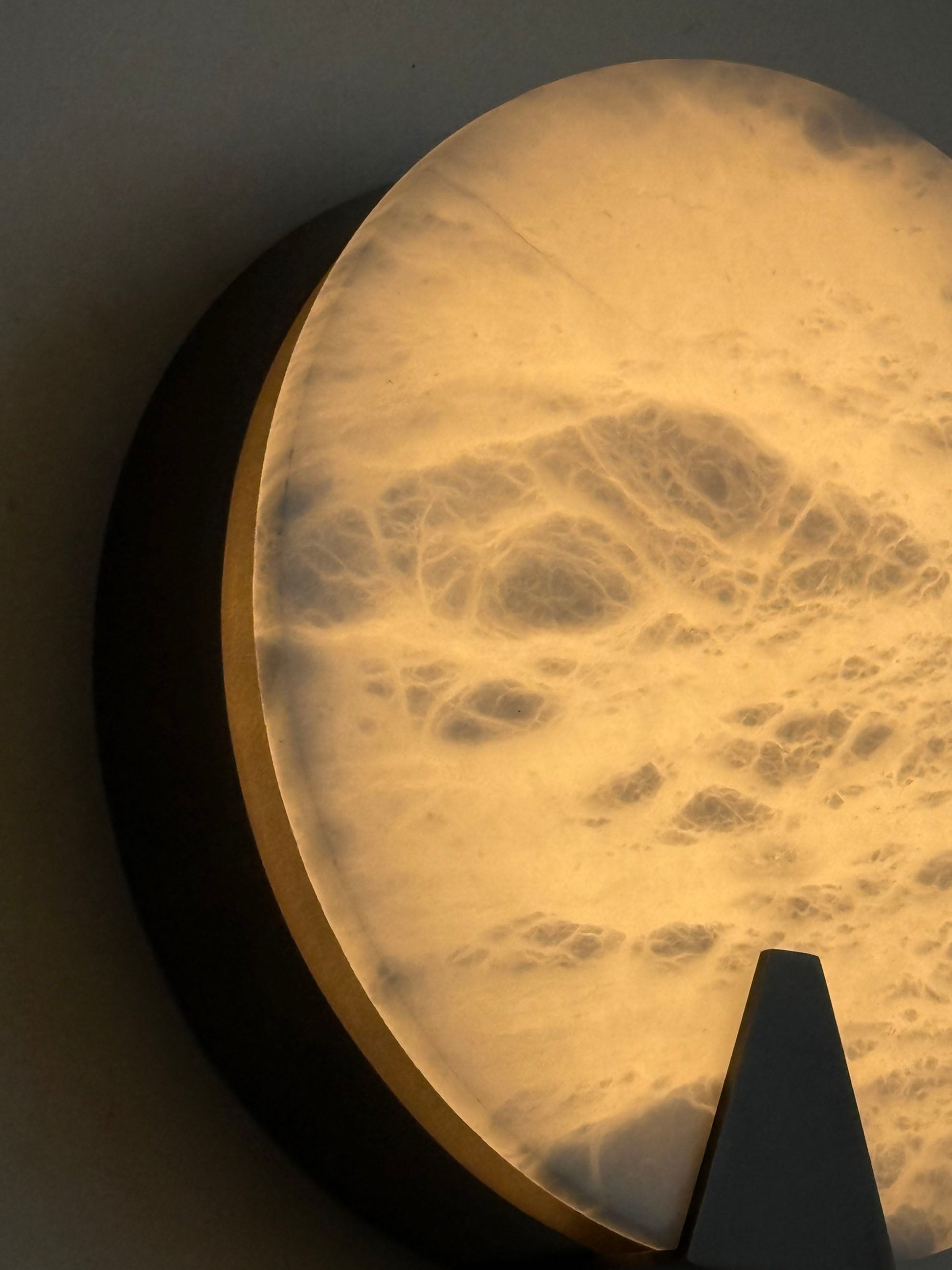 The sconce shown in context, adding ambient light to a room corner.