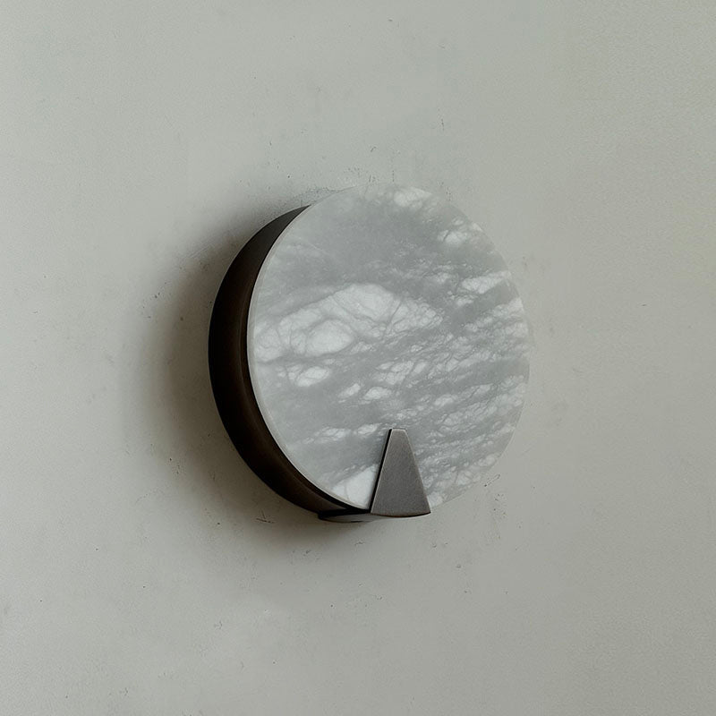 Ophelia Alabaster Sconce displayed against a dark, dramatic wall.