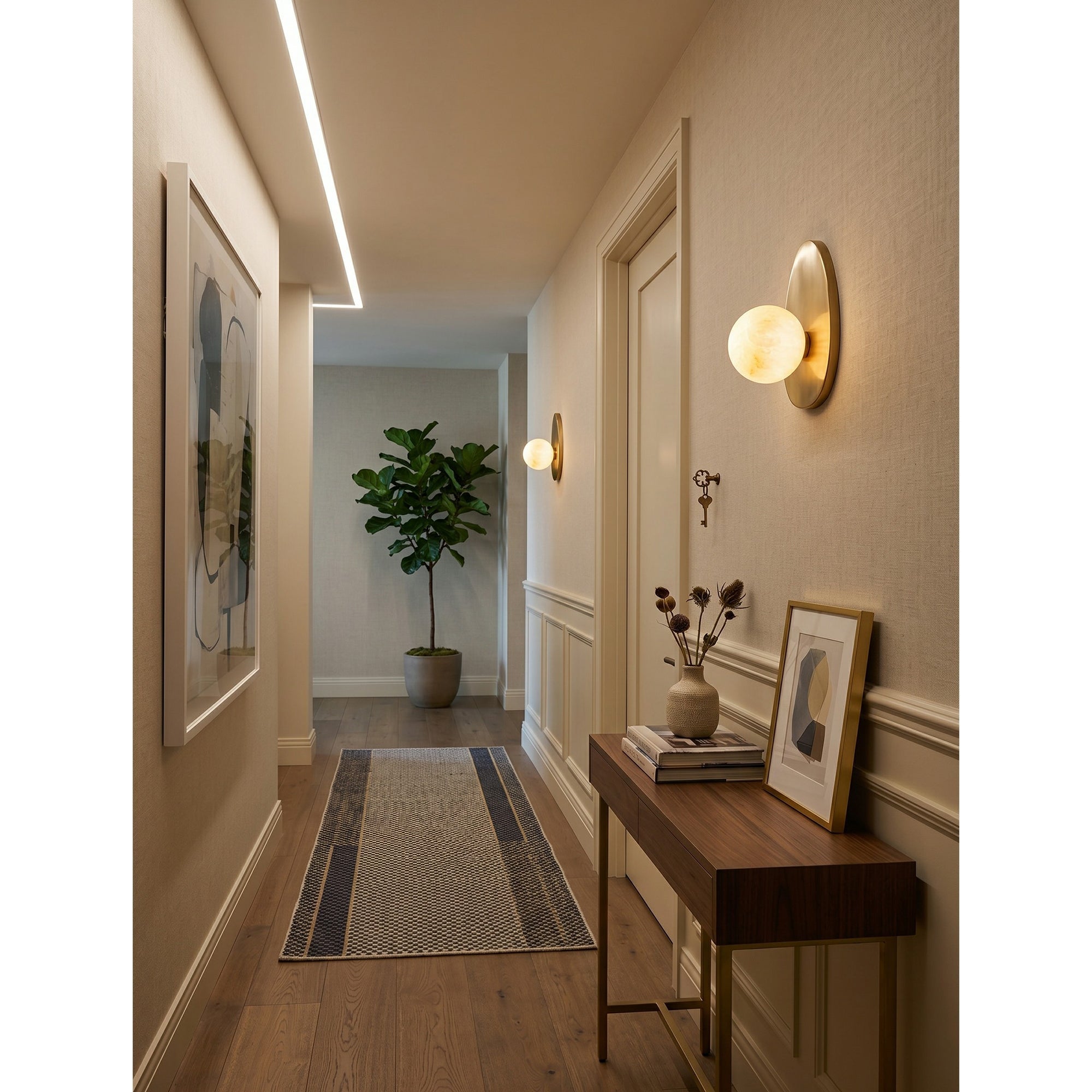 Lifestyle image of the sconce in a stylish entryway.
