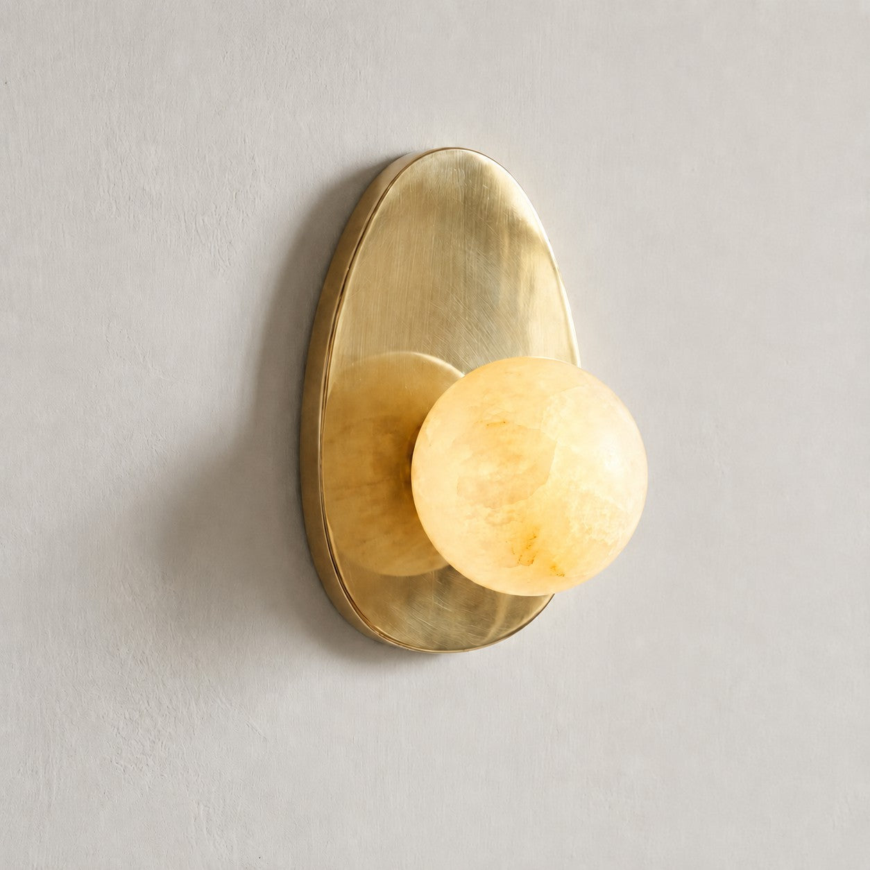 The Orba sconce as an accent light in a living room corner.