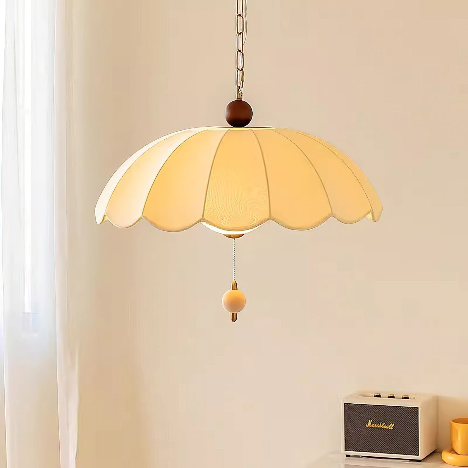 Close-up of the Oriente Pendant Light's gold and walnut details.