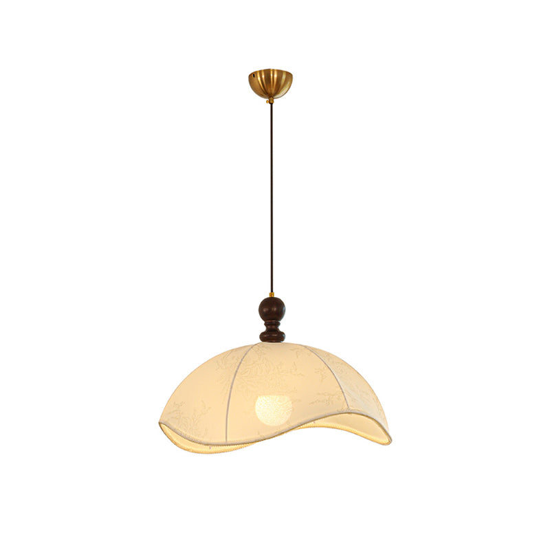 The pendant light against a dark wall to emphasize its form.