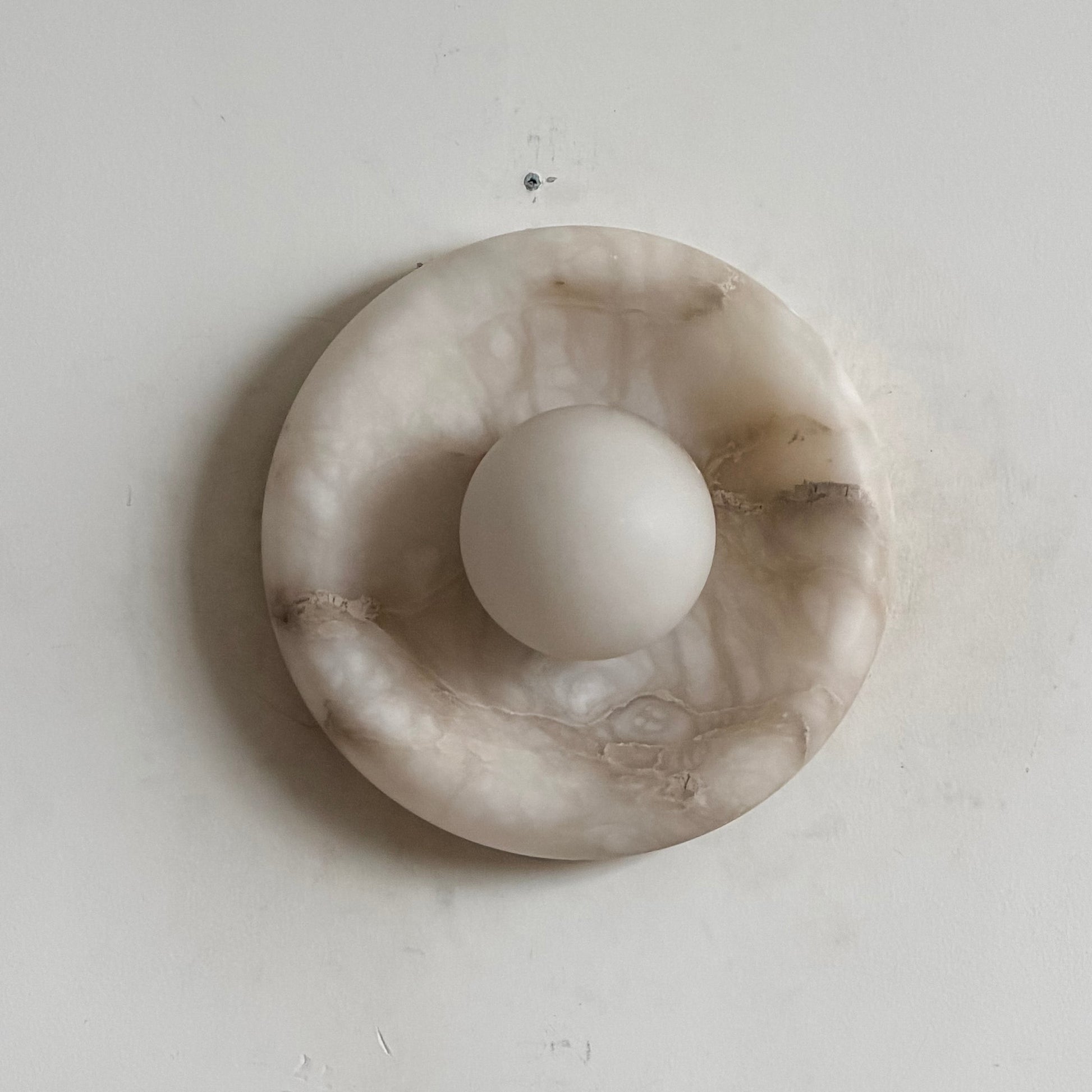 Orli Alabaster Wall Lamp providing accent lighting in a hallway.