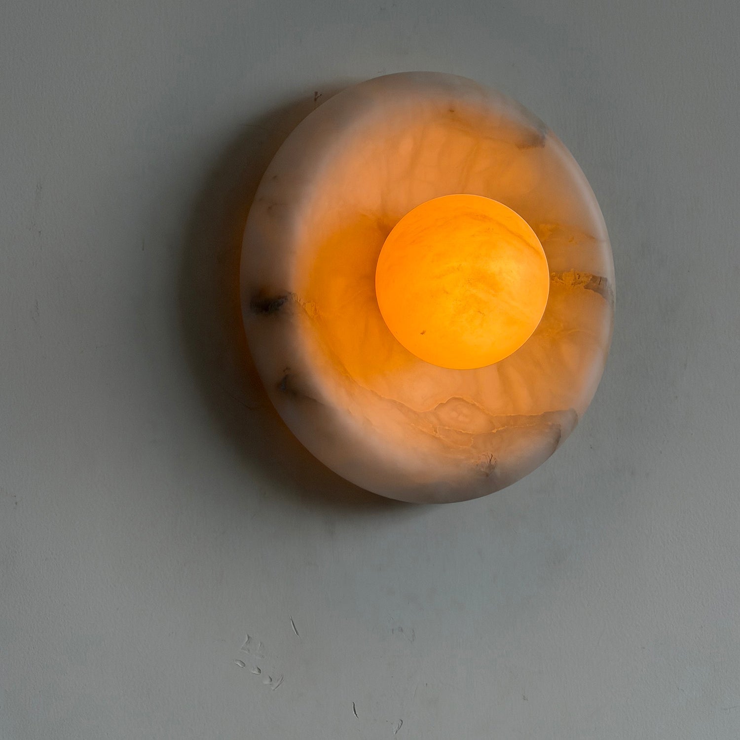 Angled view of the deep tobacco Orli Alabaster Wall Lamp.