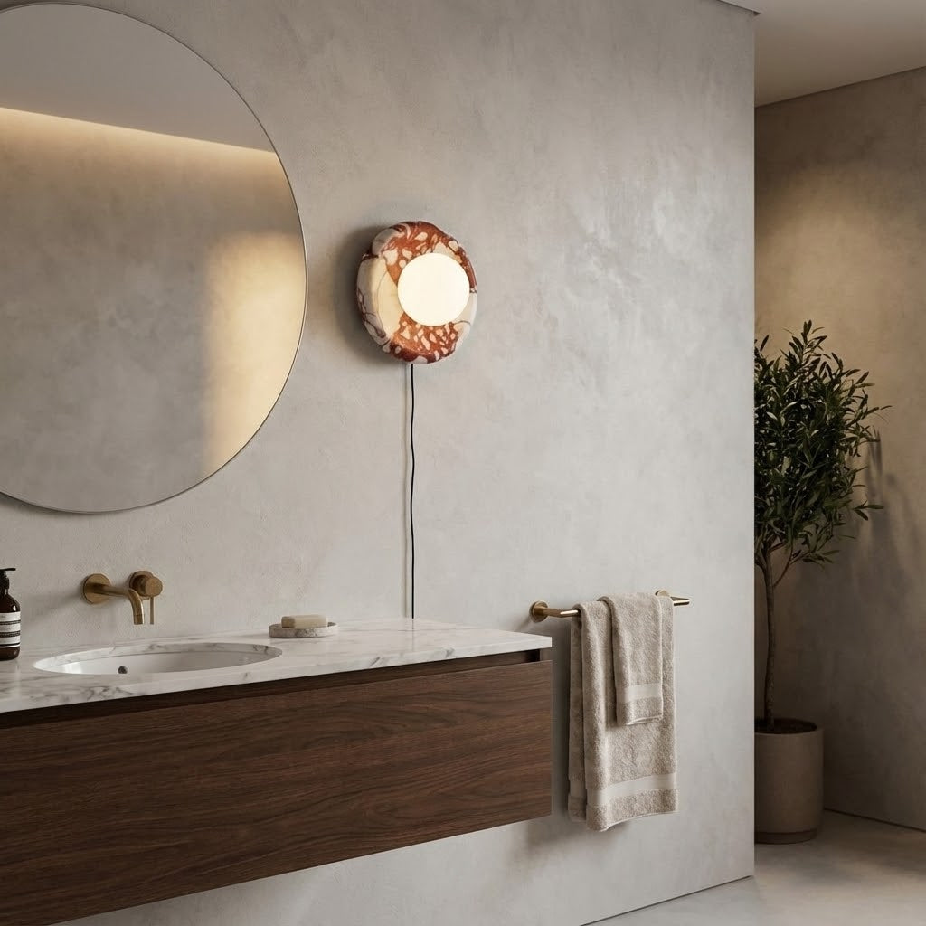 Angled view of the red marble sconce against a neutral wall.