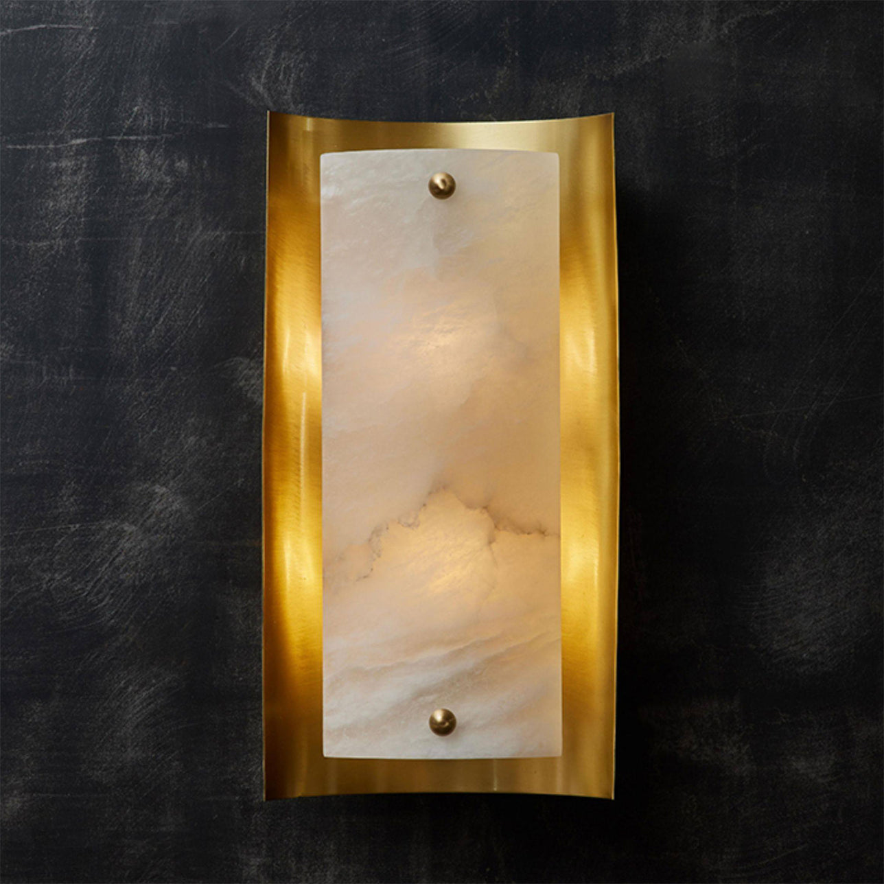 The wall lamp illuminated, casting a warm and inviting glow.
