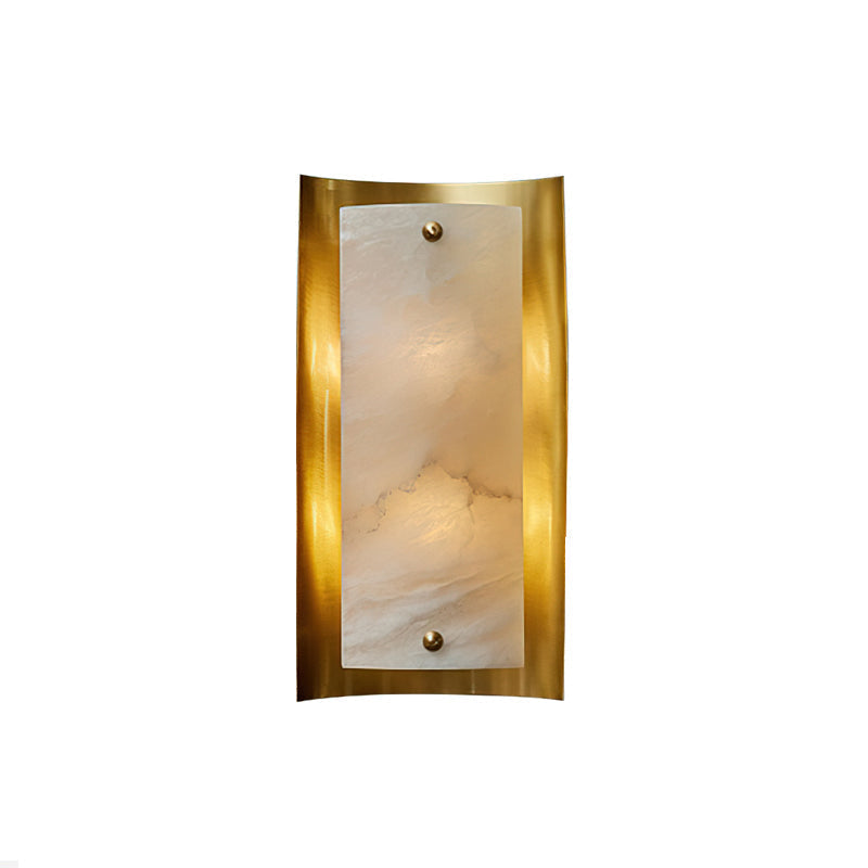 The Osman Alabaster Wall Lamp against a dark wall for contrast.