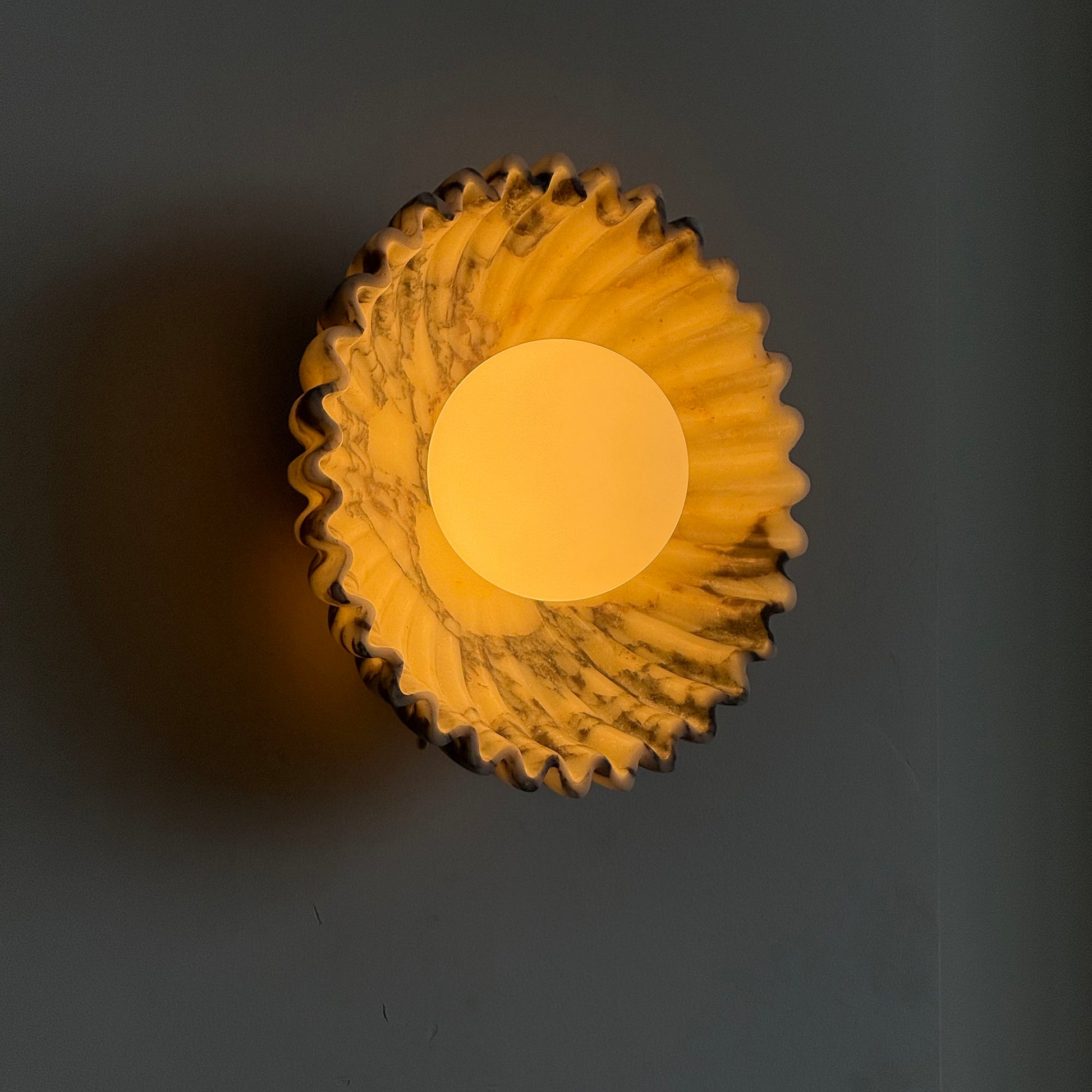 Close-up on the texture of the purple red marble sconce.