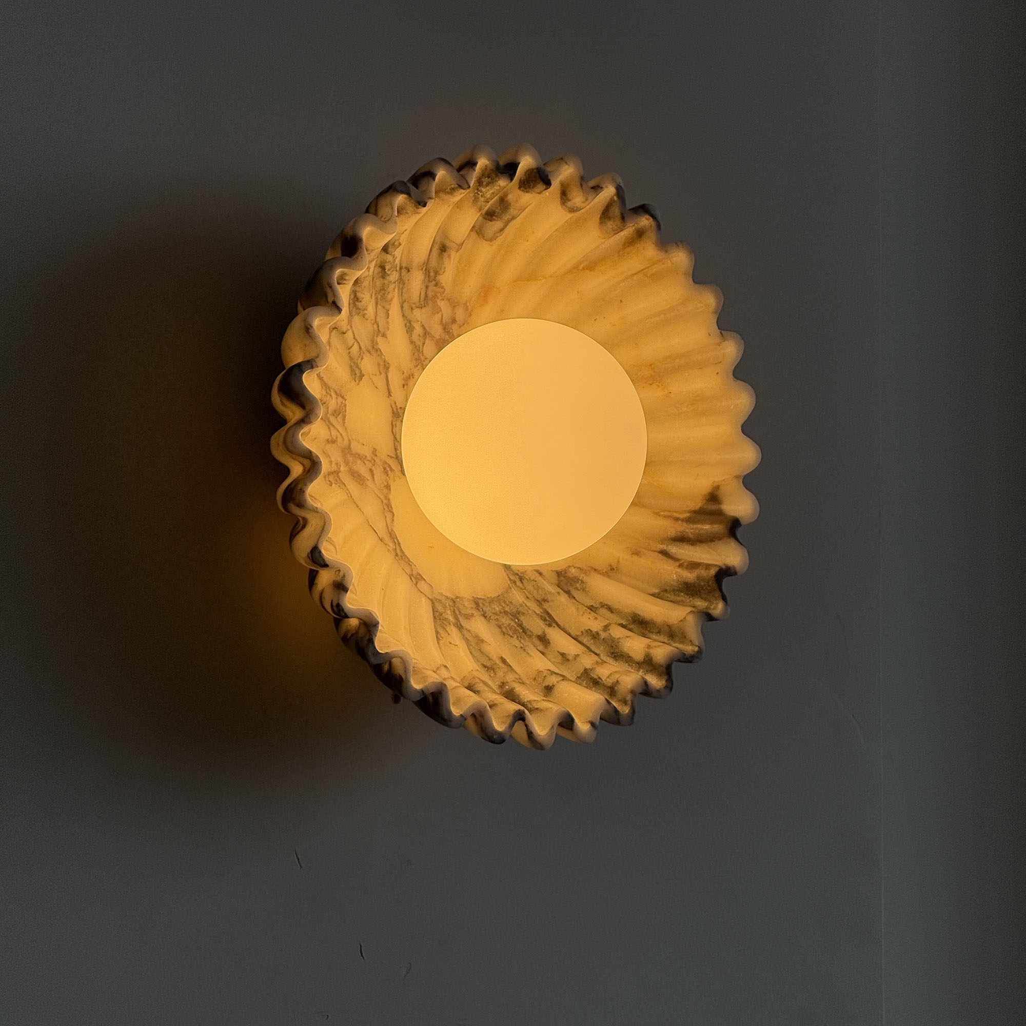 Close-up on the texture of the purple red marble sconce.