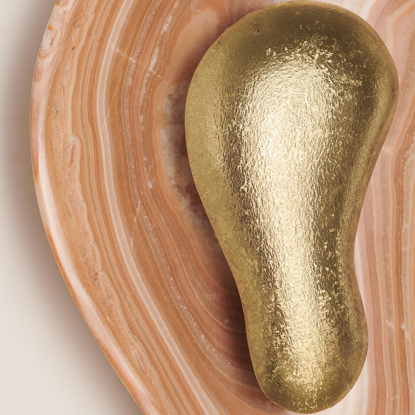 The classic brass finish option of the Oyster Hammered Onyx Sconce.