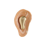 Front view of the Oyster Hammered Onyx Sconce with its sculptural brass element.