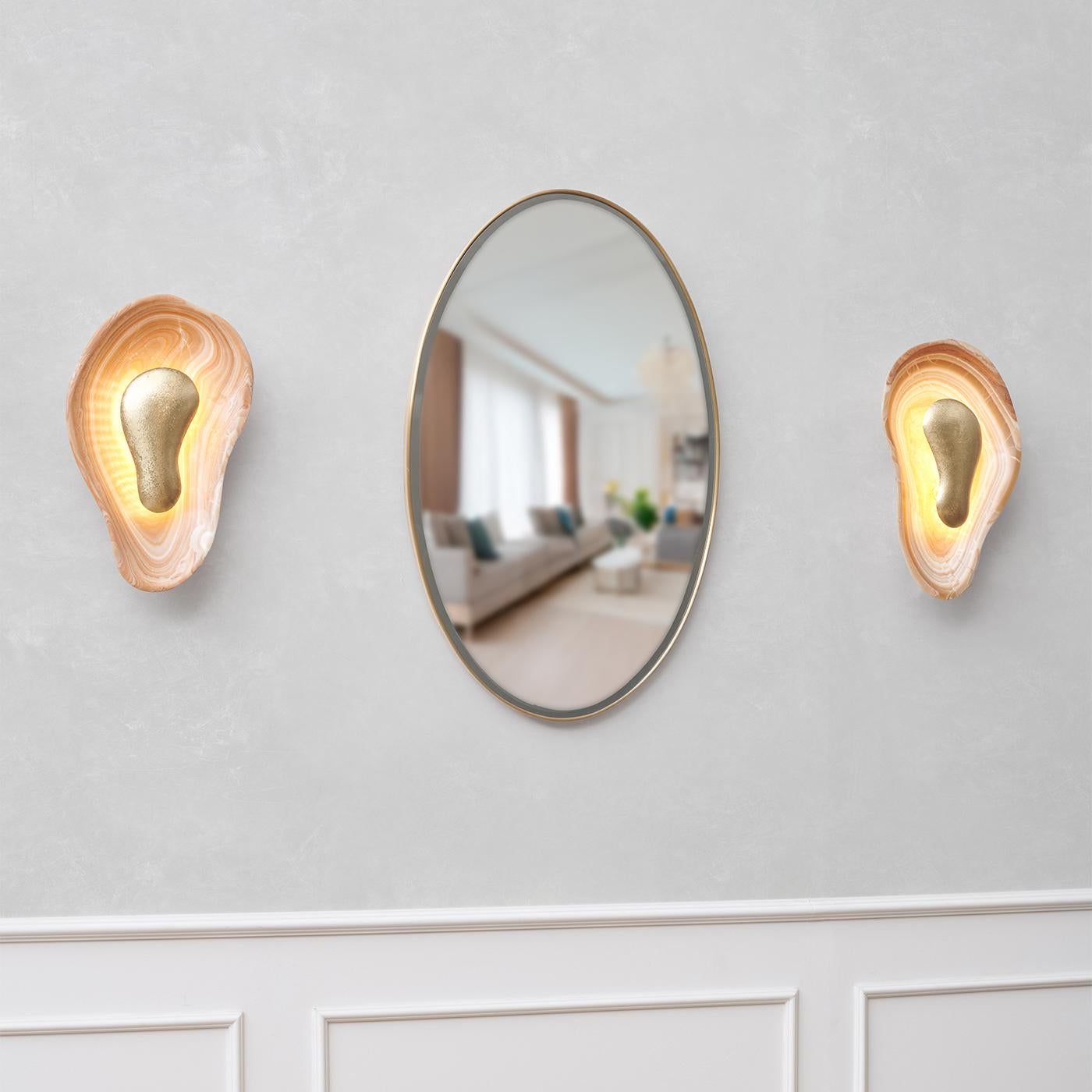 Angled shot showcasing the texture of the hammered brass and the natural onyx stone.